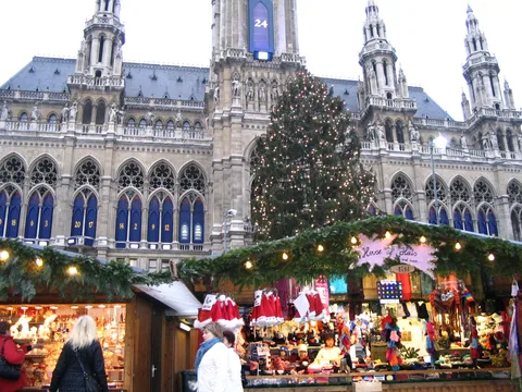 Decorated Christmas market stalls and Christmas tree outside Vienna City Hall